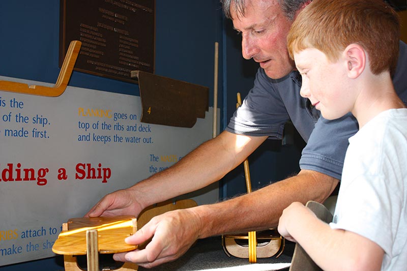 Father and son using exhibit